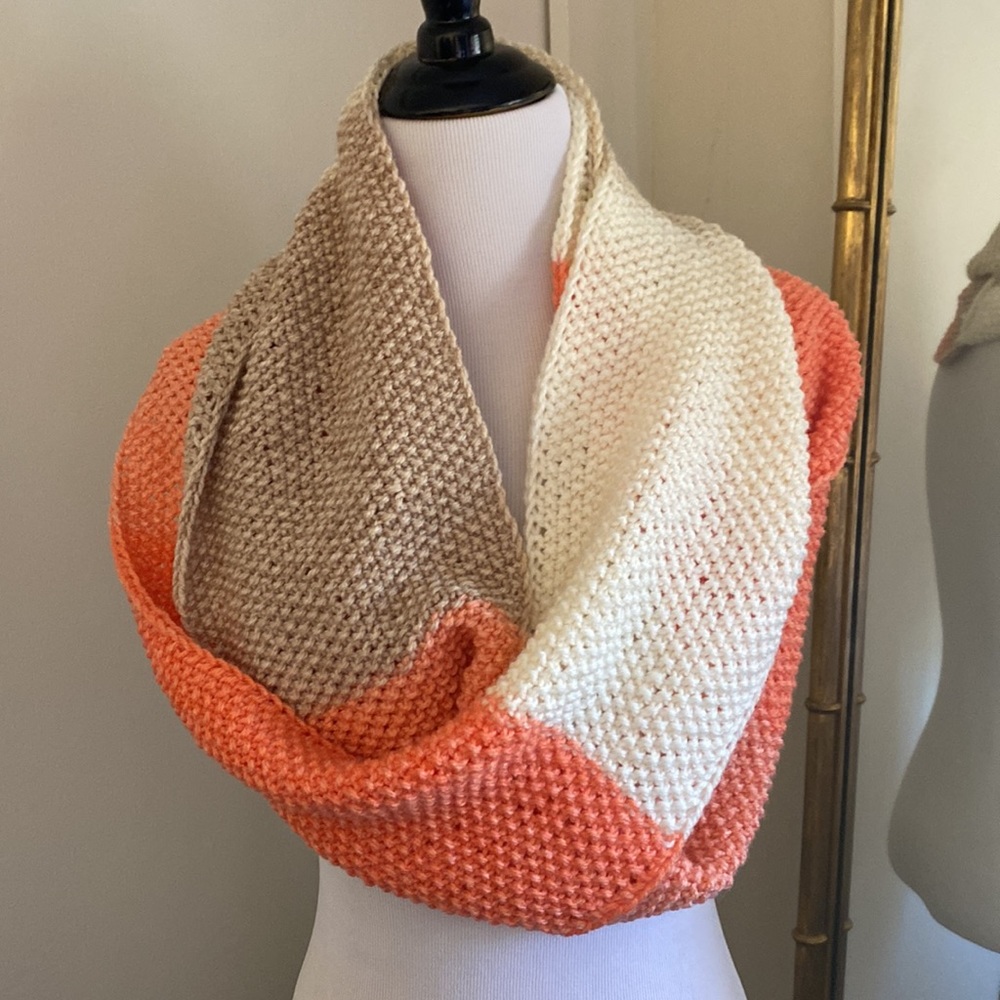 Hand knit scarf/cowl. Pretty coral, cream and sand color changes.